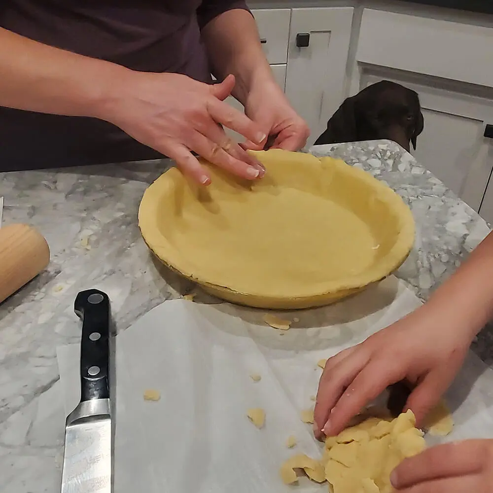 Placing the pie crust in the pan